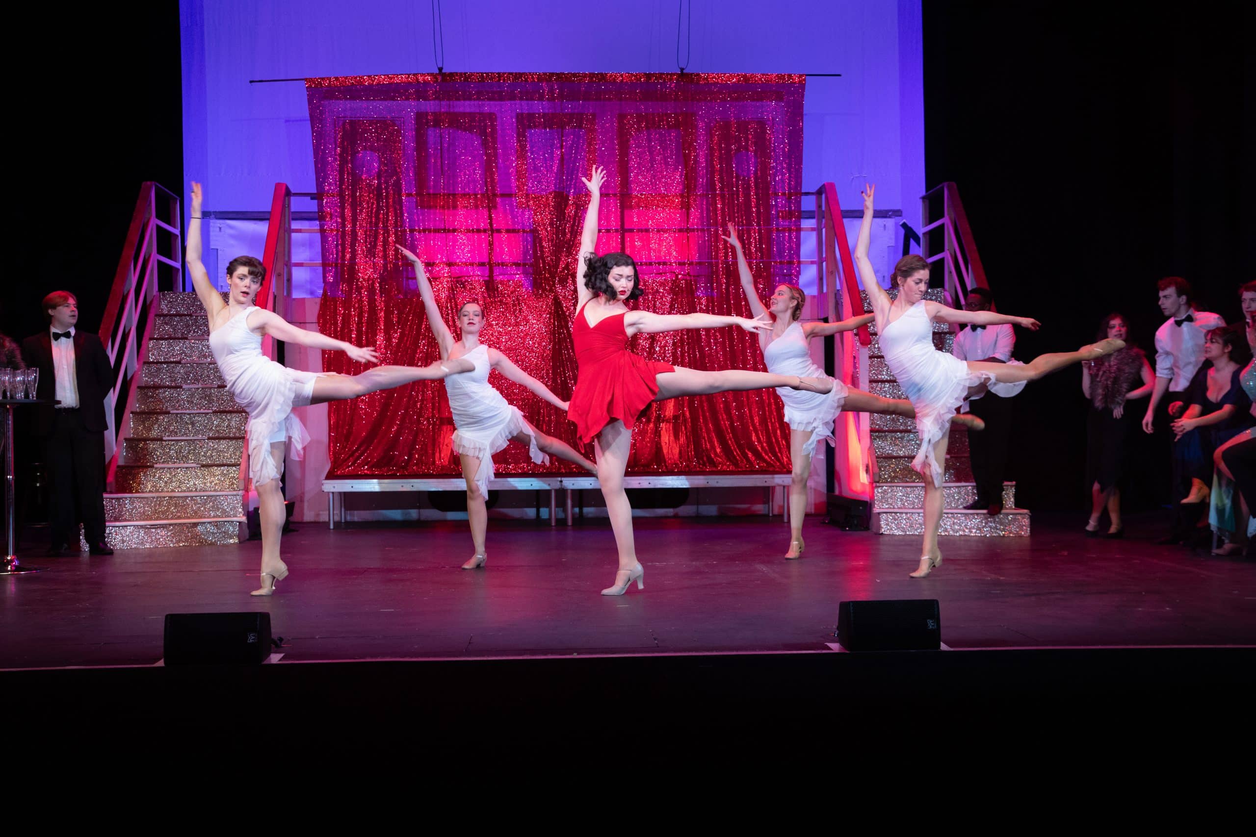 image of a theatre performance with five women dancing.