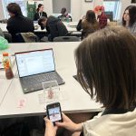 student taking image of beaded object
